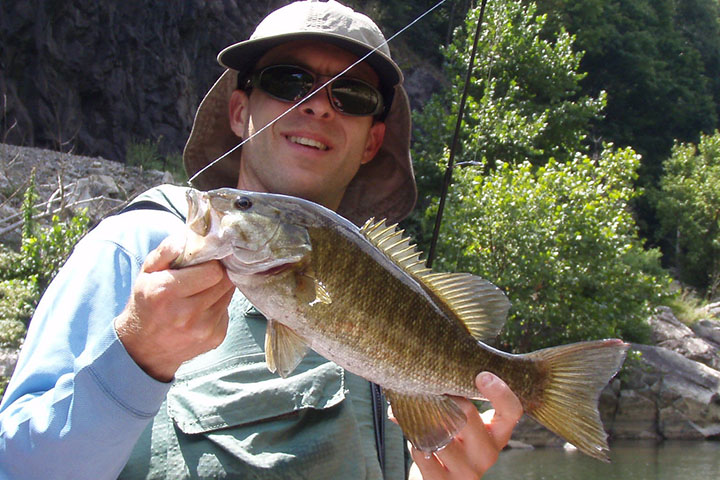man holding a smallmouth bass