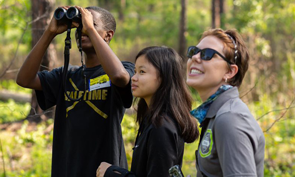 Field staff and two students perform wildlife observations